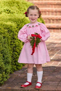 Little English traditional children's clothing.  Long sleeve pink corduroy dress with Christmas motif smocking around the neckline for little girls.