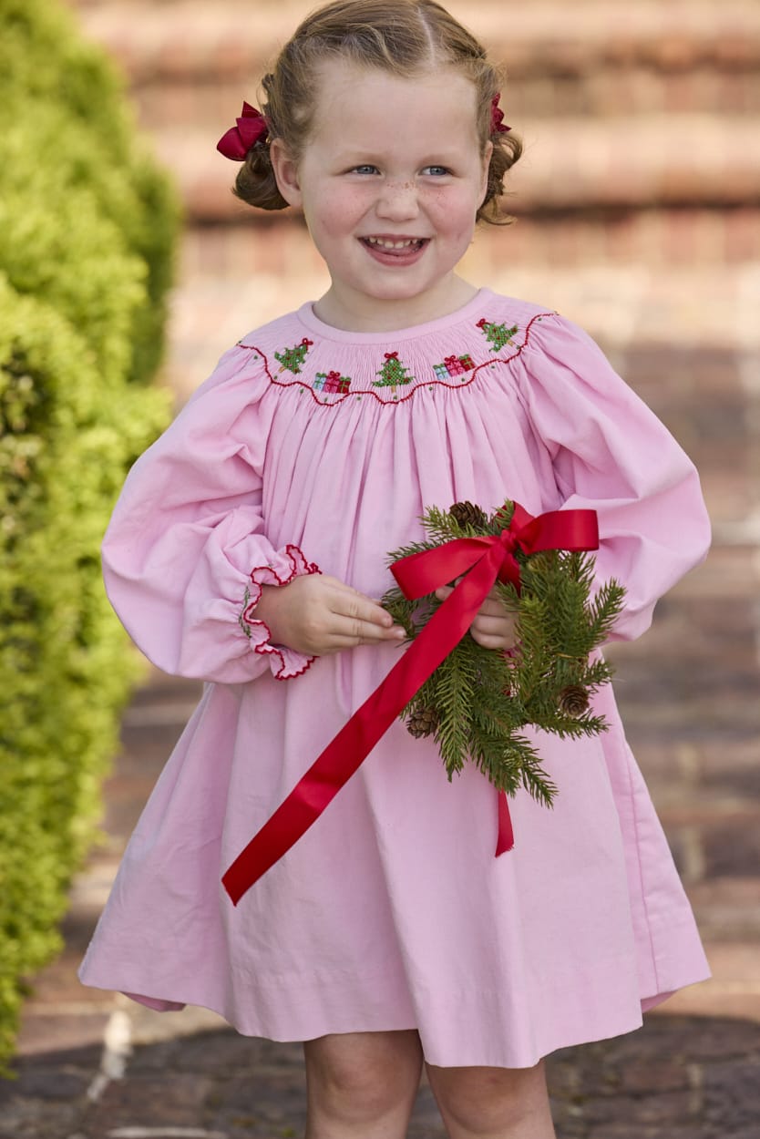 Little English traditional children's clothing.  Long sleeve pink corduroy dress with Christmas motif smocking around the neckline for little girls.