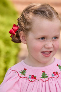 Little English traditional children's clothing.  Long sleeve pink corduroy dress with Christmas motif smocking around the neckline for little girls.