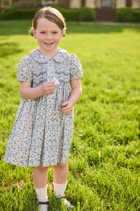 Little English traditional children's clothing. Capped sleeve blue, brown, and cream floral smocked dress with peter pan collar for little girls.