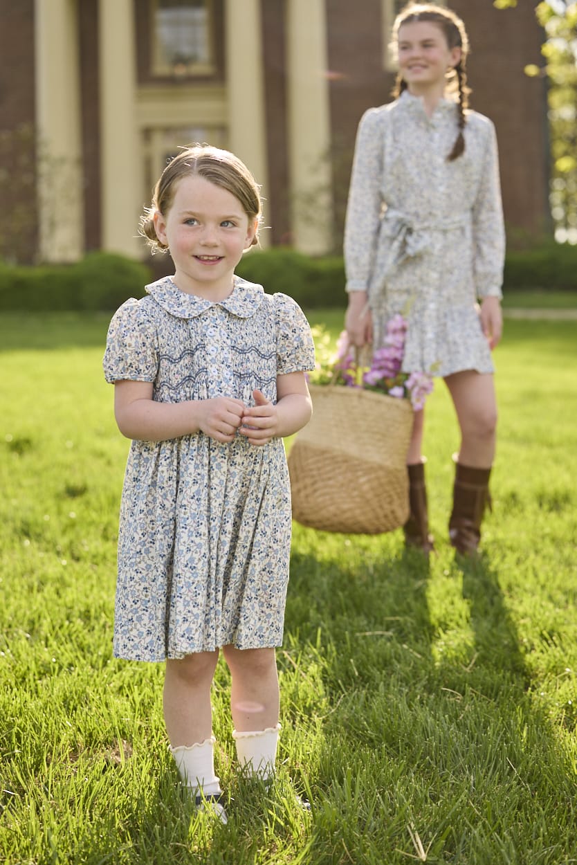 Little English traditional children's clothing. Capped sleeve blue, brown, and cream floral smocked dress with peter pan collar for little girls.