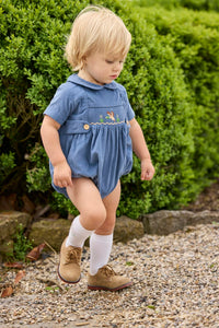 Little English classic children's clothing.  Baby boys stormy blue corduroy peter pan bubble with button tabs and flying mallard smocking across the chest.