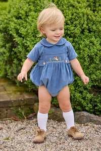 Little English classic children's clothing.  Baby boys stormy blue corduroy peter pan bubble with button tabs and flying mallard smocking across the chest.