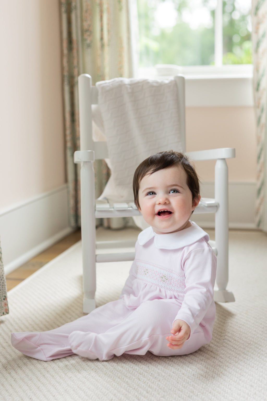 little english baby girl smocked footie with pink geo design and white peter pan collar
