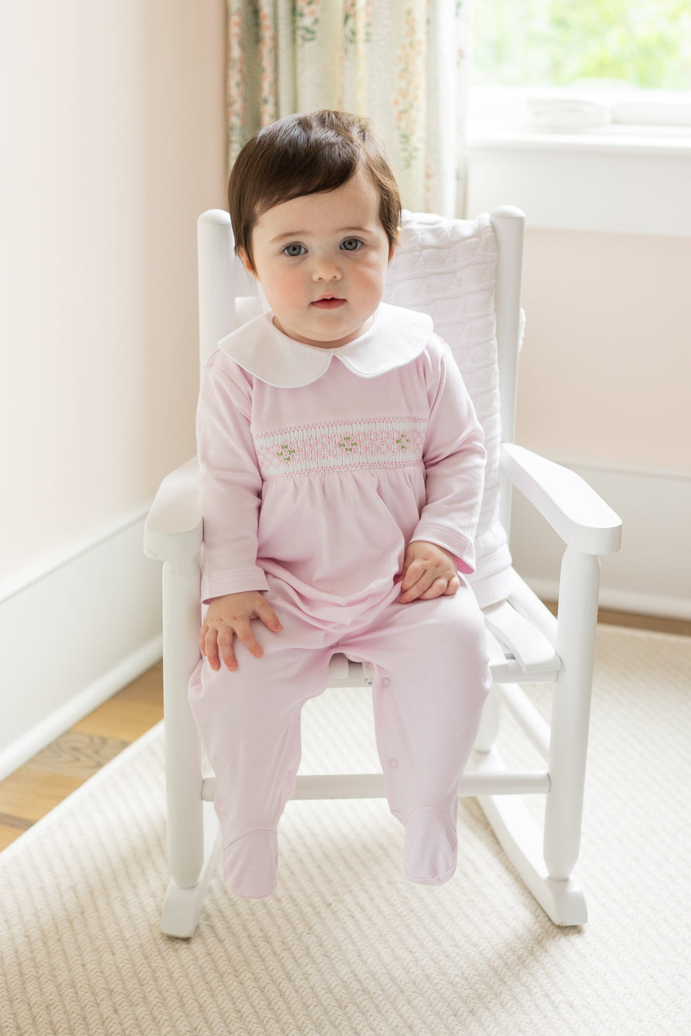 little english baby girl smocked footie with pink geo design and white peter pan collar