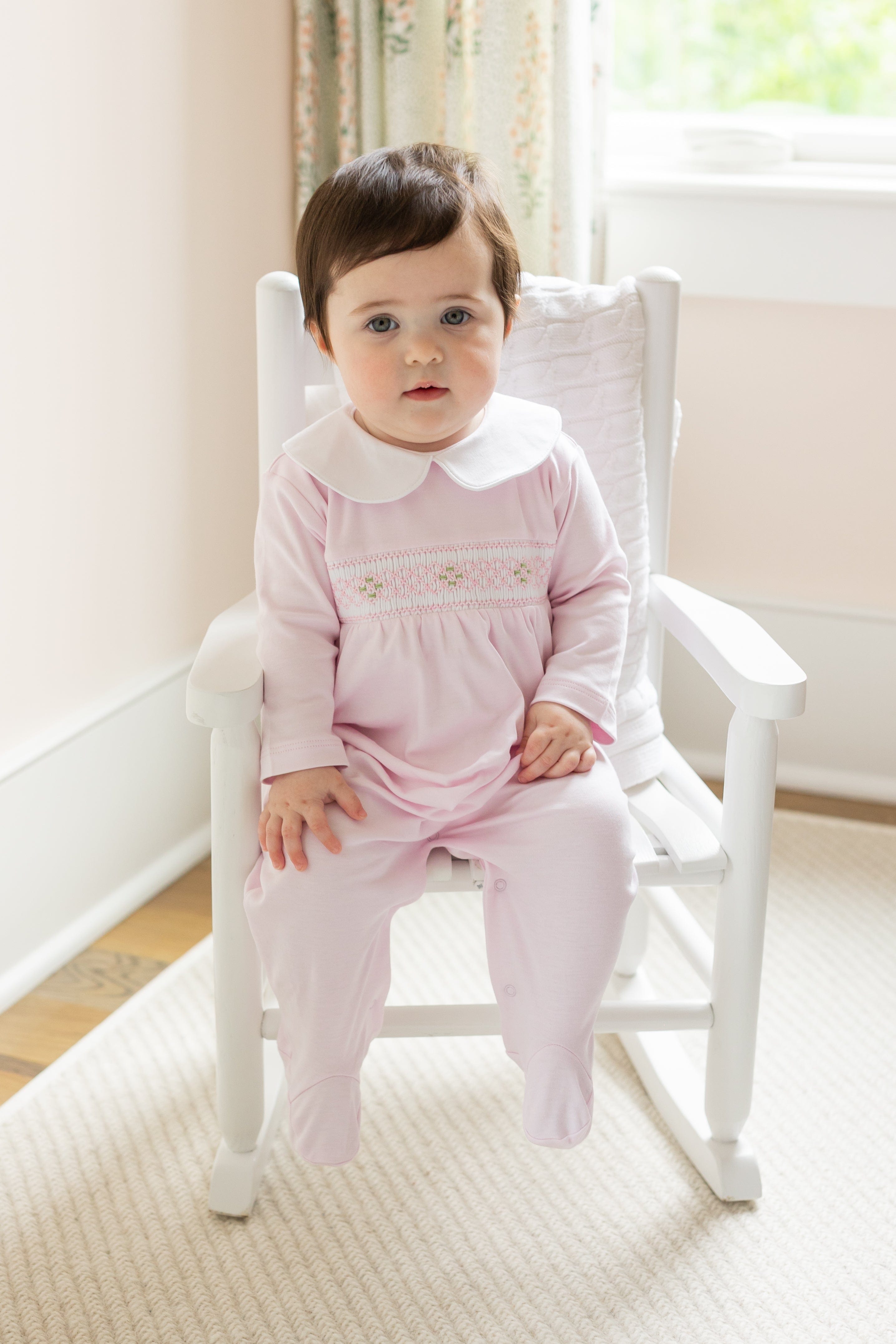 little english baby girl smocked footie with pink geo design and white peter pan collar