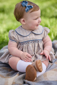 Little English classic children's clothing.  Smocked peter pan bubble in tan and blue Durham windowpane with puff sleeves and blue piping for baby girls