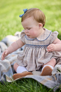 Little English classic children's clothing.  Smocked peter pan bubble in tan and blue Durham windowpane with puff sleeves and blue piping for baby girls