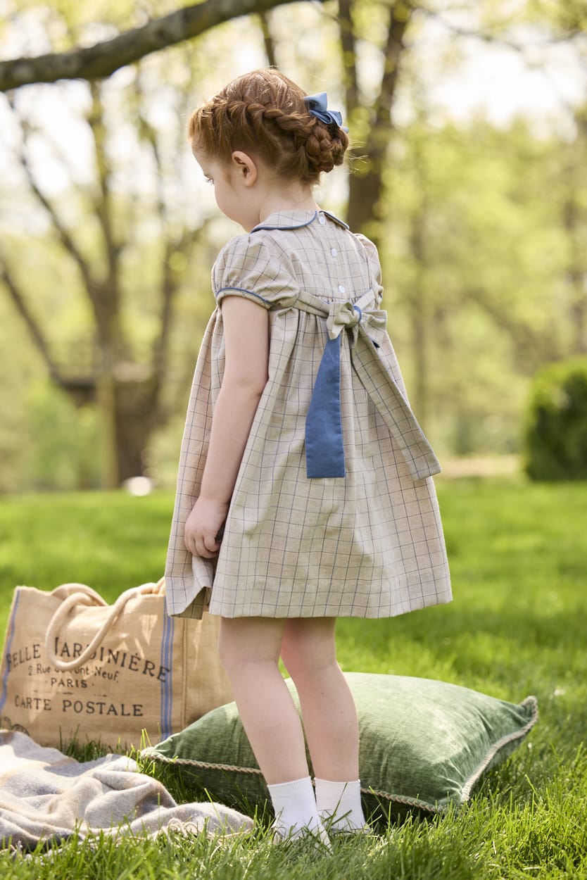 Little English traditional children's clothing.  Smocked peter pan dress in tan and blue Durham Windowpane with capped sleeves for toddler girls