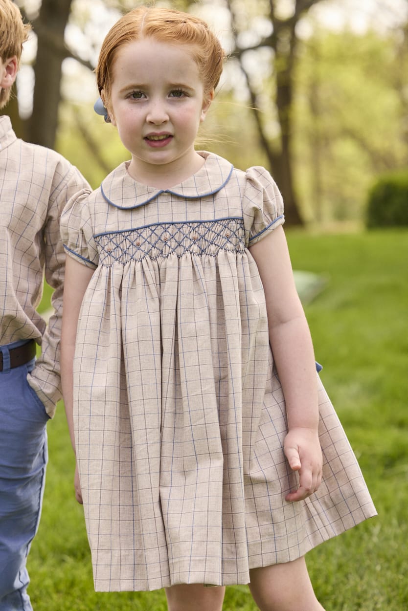 Little English traditional children's clothing.  Smocked peter pan dress in tan and blue Durham Windowpane with capped sleeves for toddler girls