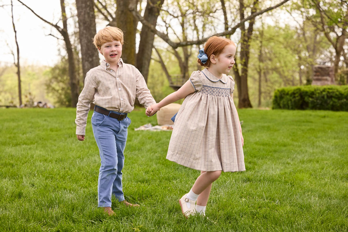 Little English traditional children's clothing.  Smocked peter pan dress in tan and blue Durham Windowpane with capped sleeves for toddler girls