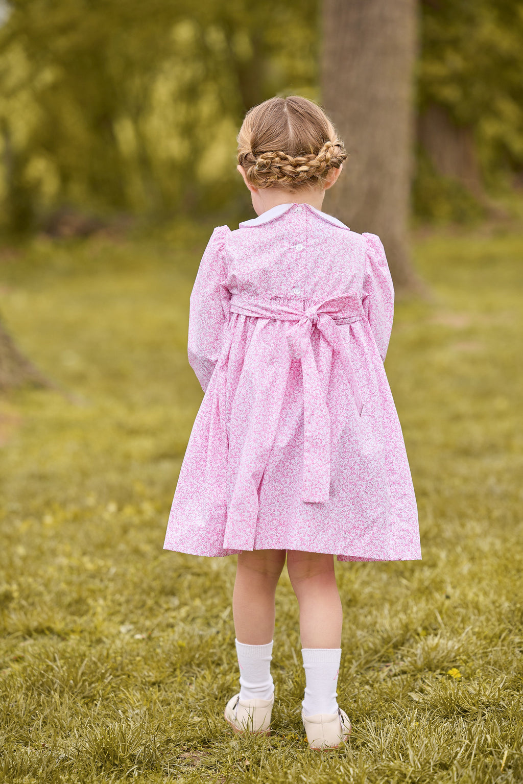 little english classic children's clothing girls pink and white floral long sleeve dress with peter pan collar, chest smocking, and bow embroidery for fall 