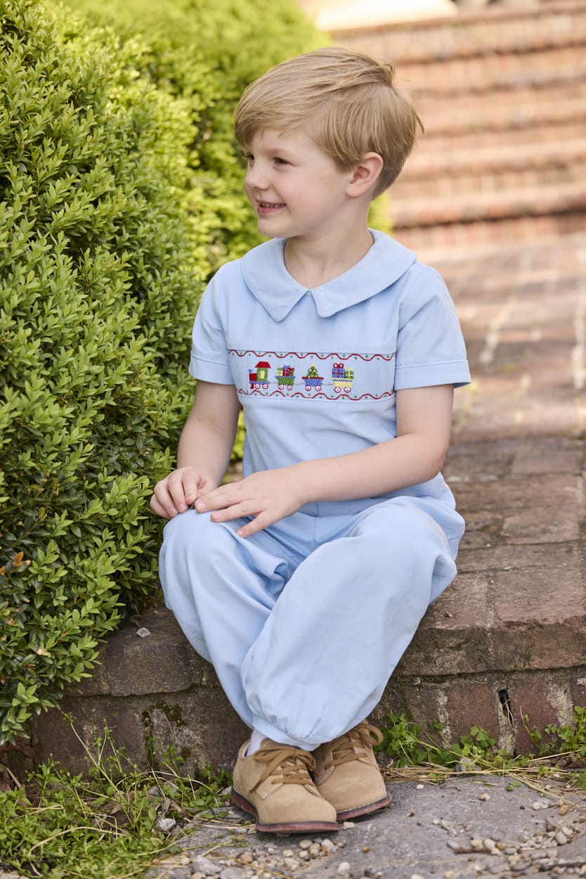 Little English traditional children's clothing. Boys blue corduroy set - banded pants paired with Eaton collar short sleeve top with holiday train smocking across the chest.
