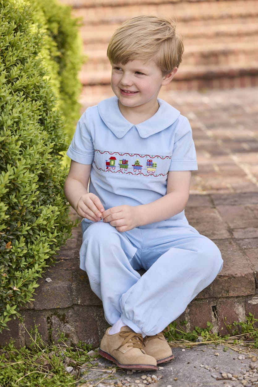 Little English traditional children's clothing. Boys blue corduroy set - banded pants paired with Eaton collar short sleeve top with holiday train smocking across the chest.
