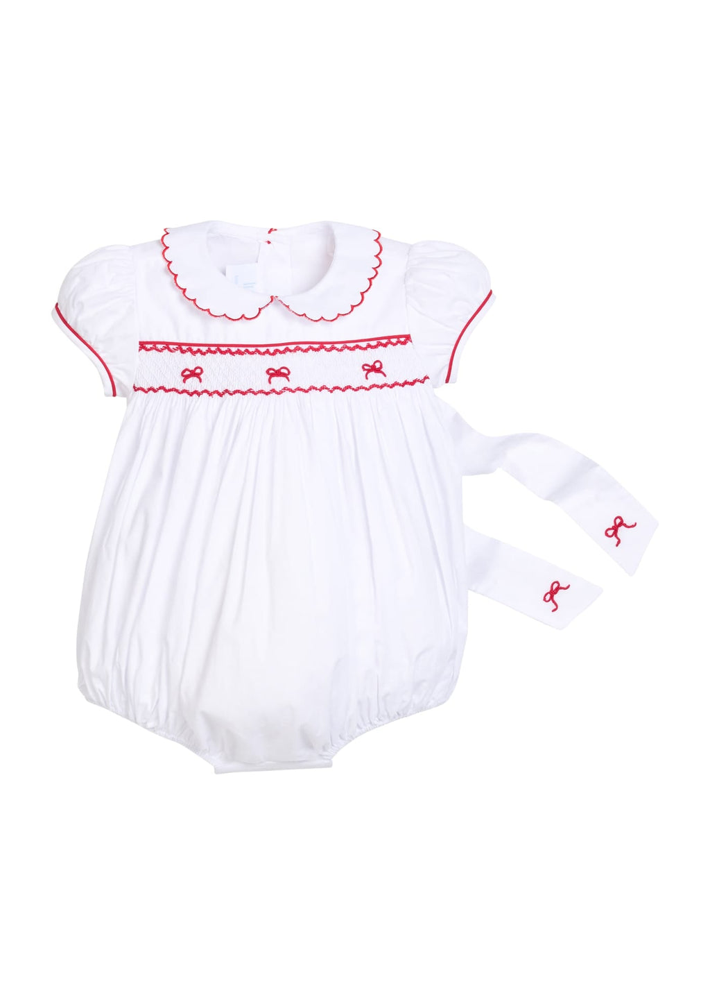 Little English traditional children's clothing, Puff sleeve white peter pan bubble with scalloped collar, red trim, and bow smocking across the chest. Dressy outfit for baby girls for the holiday