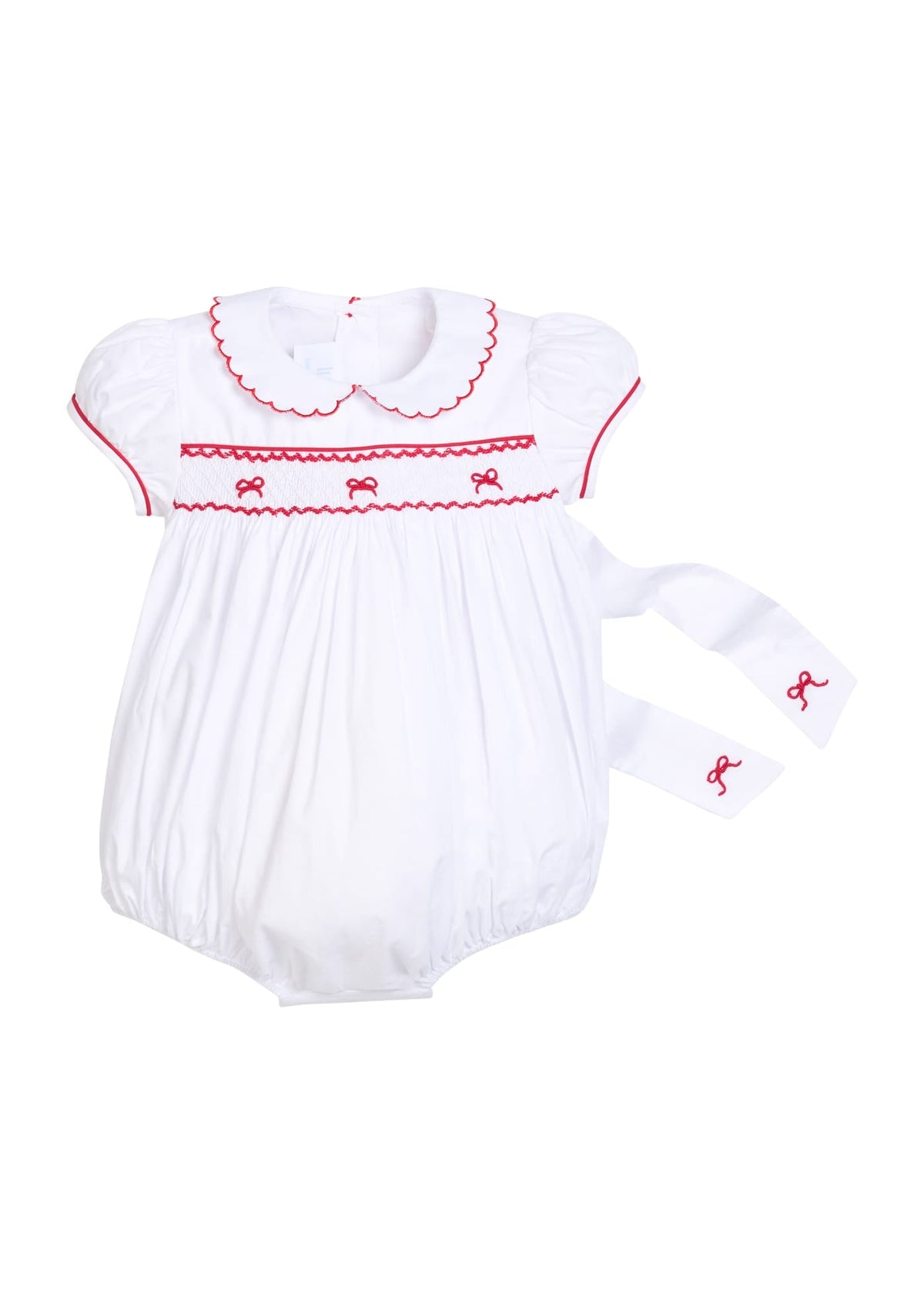 Little English traditional children's clothing, Puff sleeve white peter pan bubble with scalloped collar, red trim, and bow smocking across the chest. Dressy outfit for baby girls for the holiday