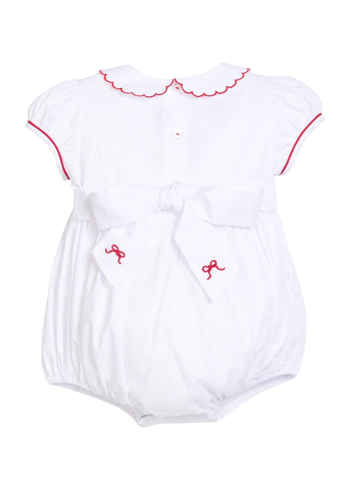 Little English traditional children's clothing.  Puff sleeve white peter pan bubble with scalloped collar, red trim, and bow smocking across the chest.  Dressy outfit for baby girls for the holiday