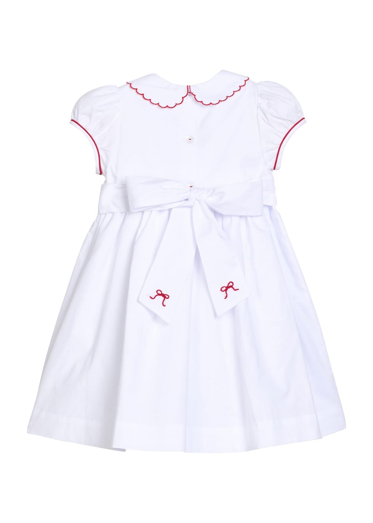 Little English traditional children's clothing.  Puff sleeve white peter pan dress with scalloped collar, red trim, and bow smocking across the chest.  Dressy outfit for little girls for the holiday