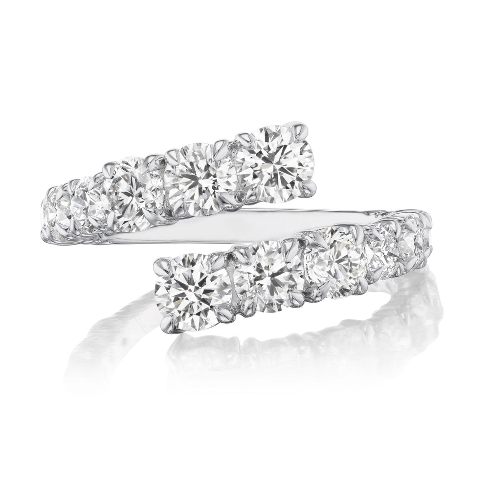 The Graduated Round Diamond Wraparound Ring in White Gold showcases two rows of G-H color round diamonds set side by side, overlapping at the ends, and is displayed on a reflective white surface.