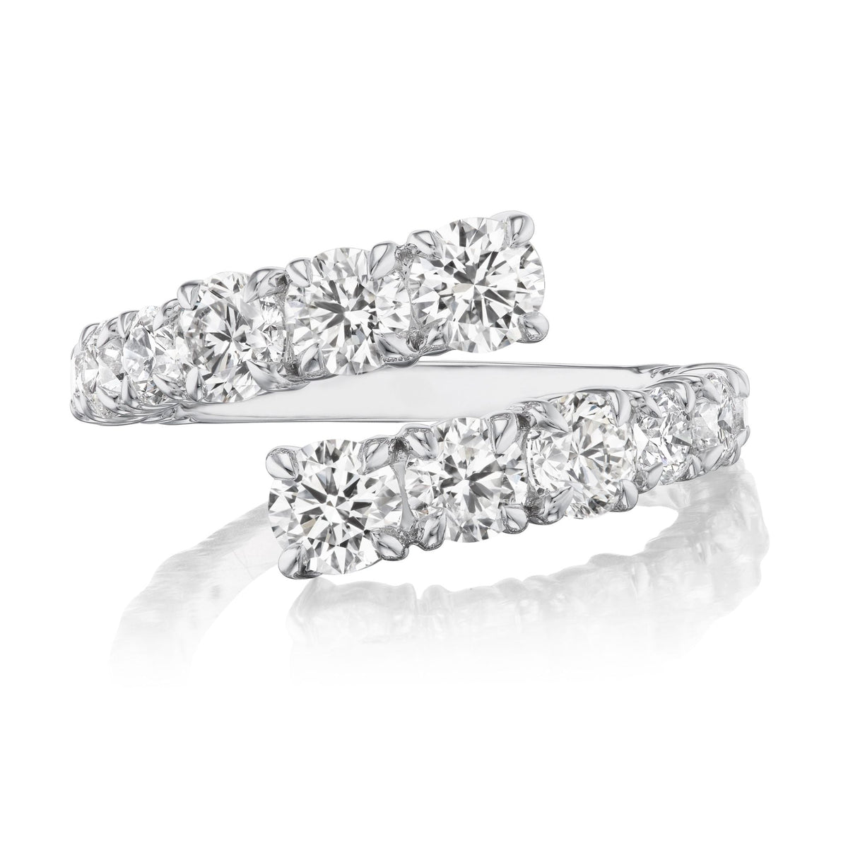 The Graduated Round Diamond Wraparound Ring in White Gold showcases two rows of G-H color round diamonds set side by side, overlapping at the ends, and is displayed on a reflective white surface.