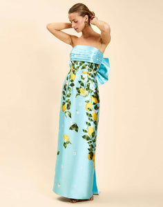 Solstice Gown in Sorrento Citrus poly silk twill with strapless neckline, removable bow, convertible bodice, and side pockets.