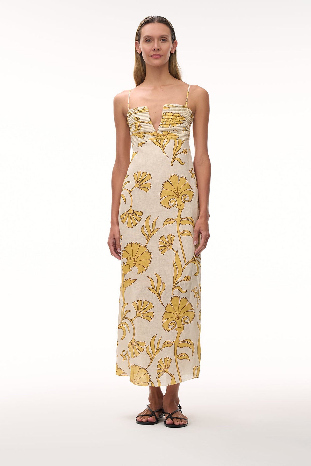 Front view of Antigüa Linen Midi Dress in Yellow Flowers showing hand-pleated cups and fitted waist against white background