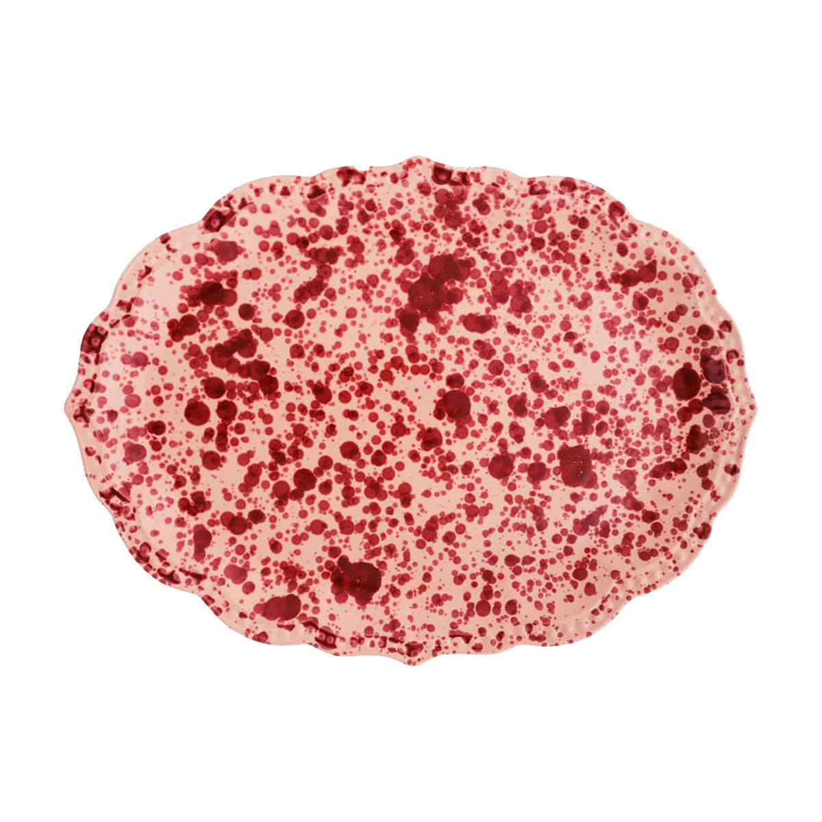 Top view of speckled serving plate showing pink base with red splatter glaze and scalloped oval edge on white background