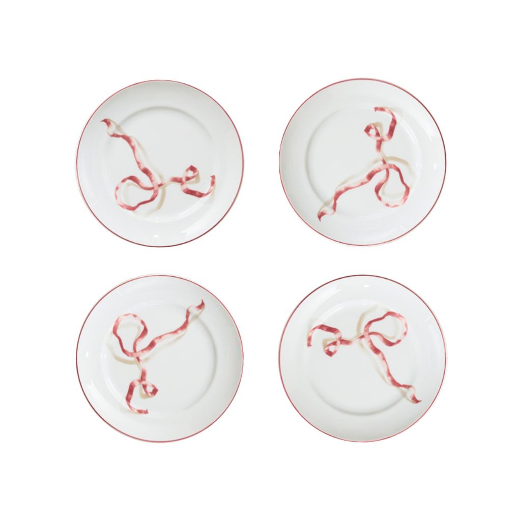 A set of four ribbon dessert plates in pink. HarperÕs Bazaar Best Hostess Gifts for Dinner Parties, Movie Nights, and More. These ribbon-adorned dinner plates can transform even an easy meal into something fit for a downtown It-girl. With three different colors to choose from, you can find the perfect option for home design lovers.