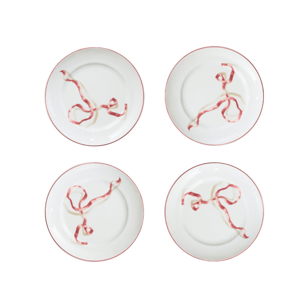 A set of four ribbon dessert plates in pink. HarperÕs Bazaar Best Hostess Gifts for Dinner Parties, Movie Nights, and More. These ribbon-adorned dinner plates can transform even an easy meal into something fit for a downtown It-girl. With three different colors to choose from, you can find the perfect option for home design lovers.