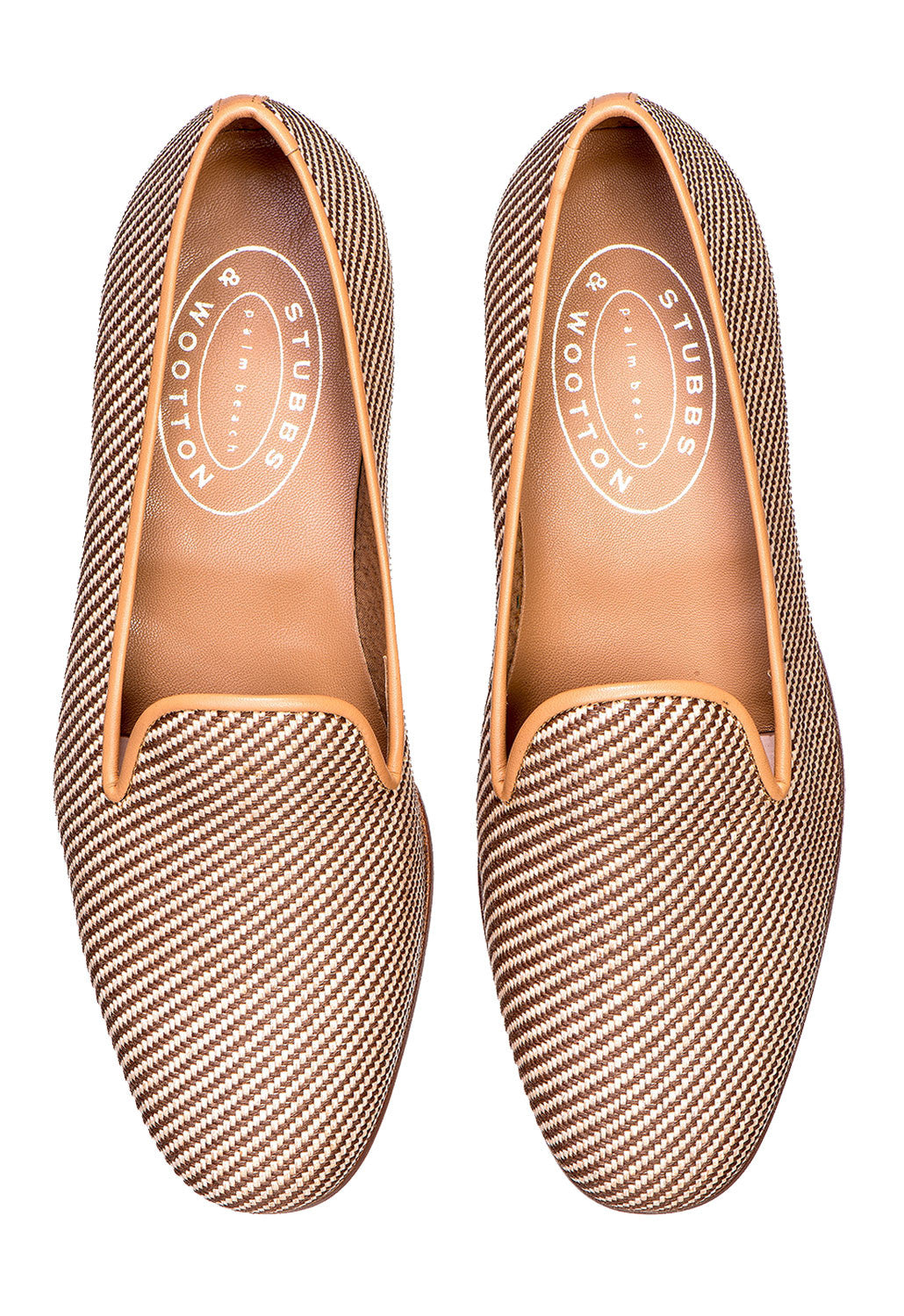 Top view of Straw Raffia Slipper pair showing woven natural straw upper and tan leather trim on white background