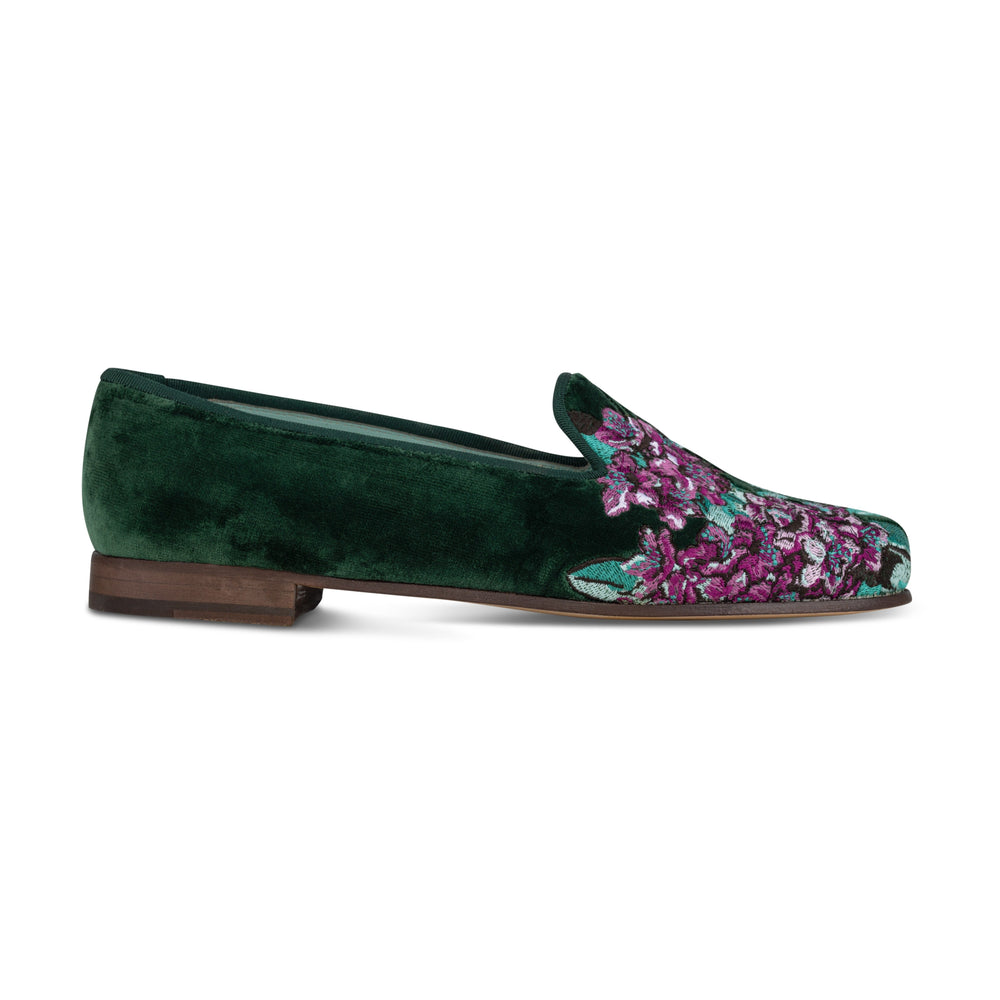 Side view of Rhododendron Hunter slipper with green velvet purple floral embroidery and low wooden heel on white background