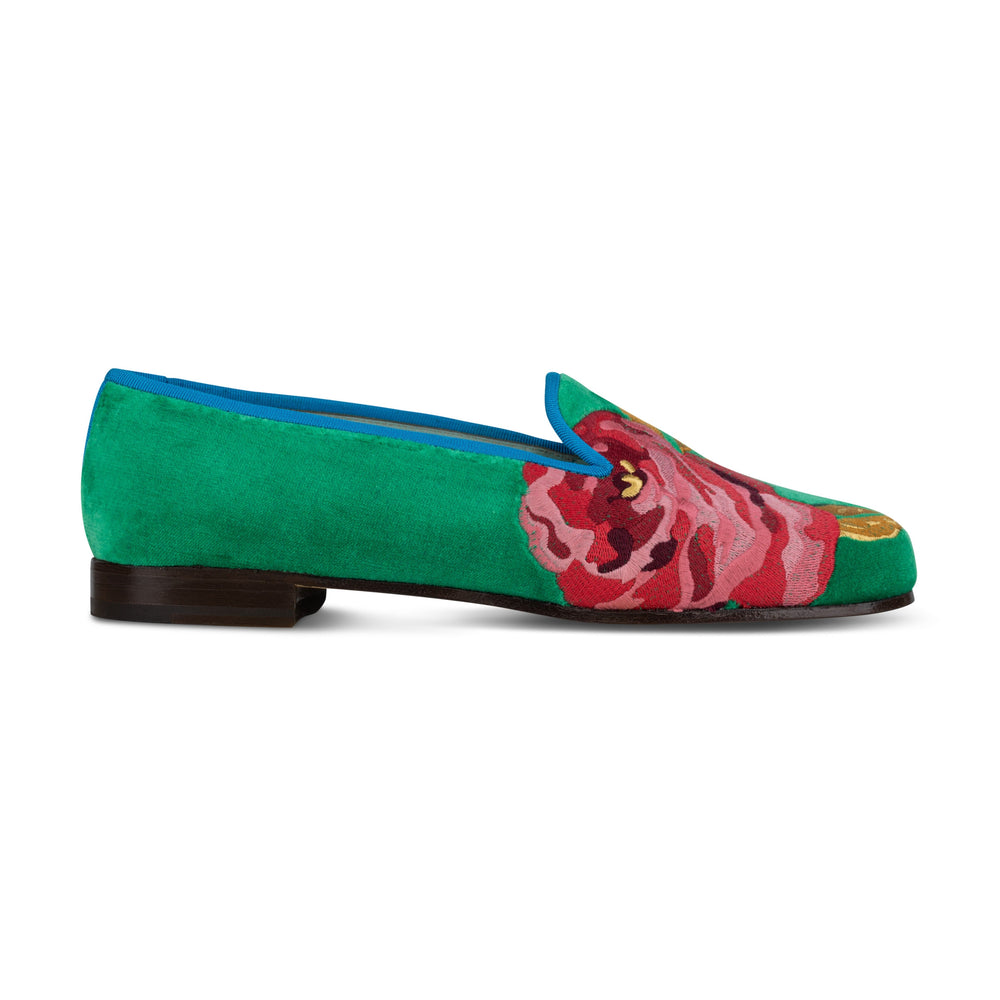 Side view of Grace Rose emerald velvet slipper showcasing large pink rose embroidery, blue trim and low stacked wooden heel on white background