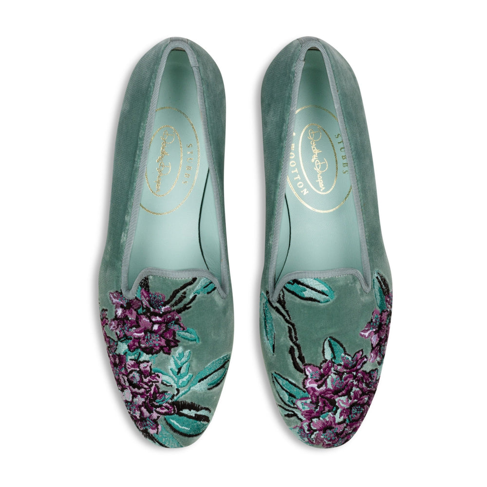 Top view of pair of Rhododendron Mint velvet slippers showcasing purple rhododendron embroidery and mint insoles on white background