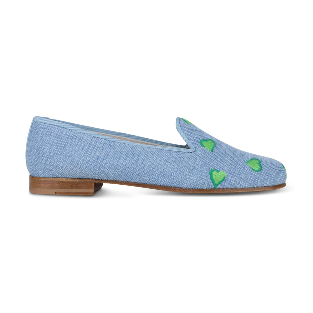 Side view of Hearts chambray linen slipper showcasing green embroidered hearts and stacked wooden heel on white background