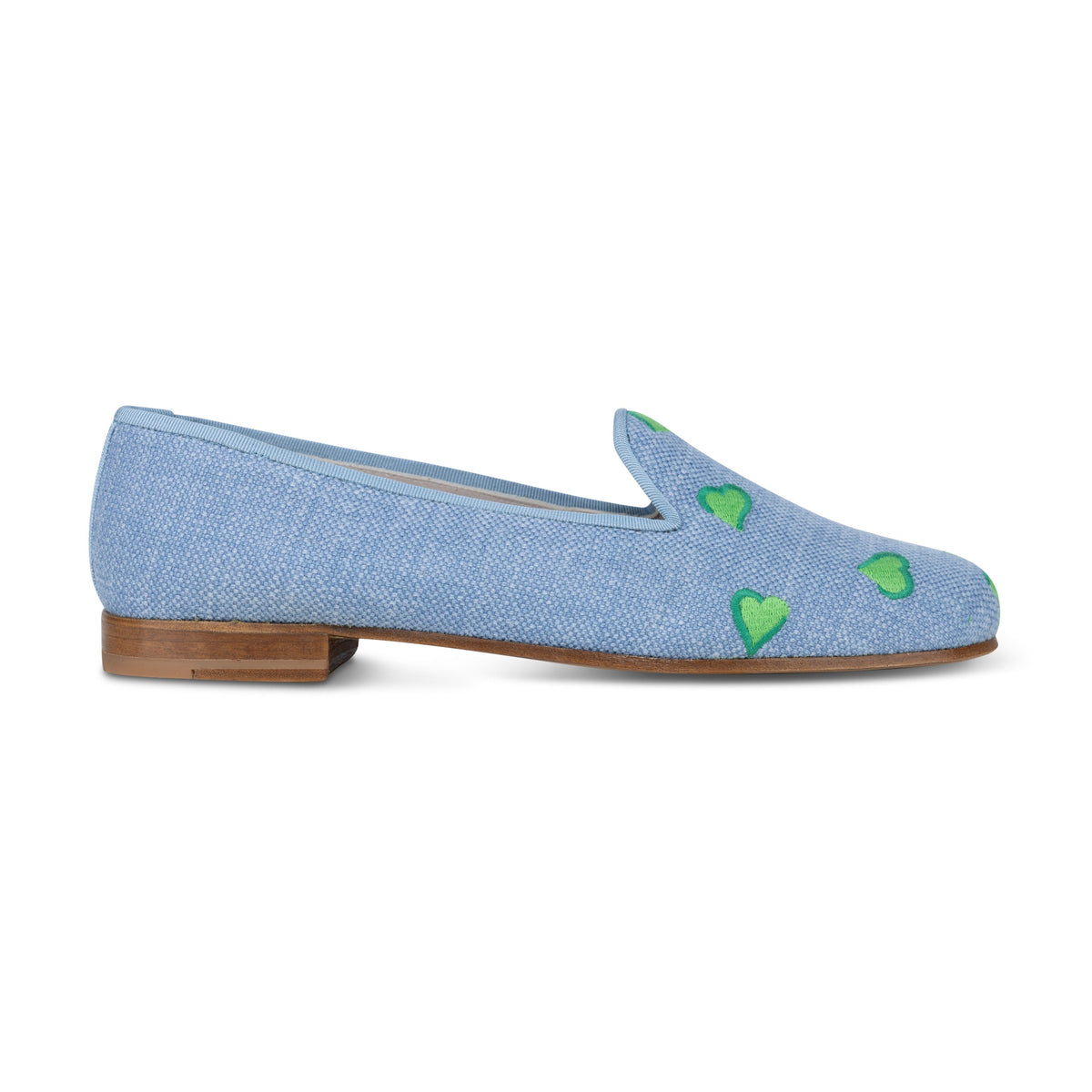 Side view of Hearts chambray linen slipper showcasing green embroidered hearts and stacked wooden heel on white background