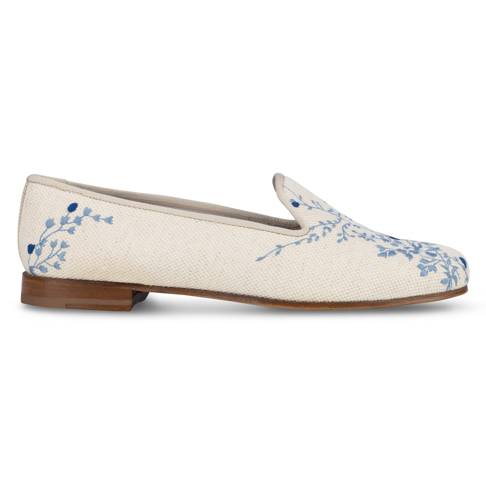 Side profile of Fleurs Flax Linen slipper showcasing blue floral embroidery and low stacked wooden heel on white background