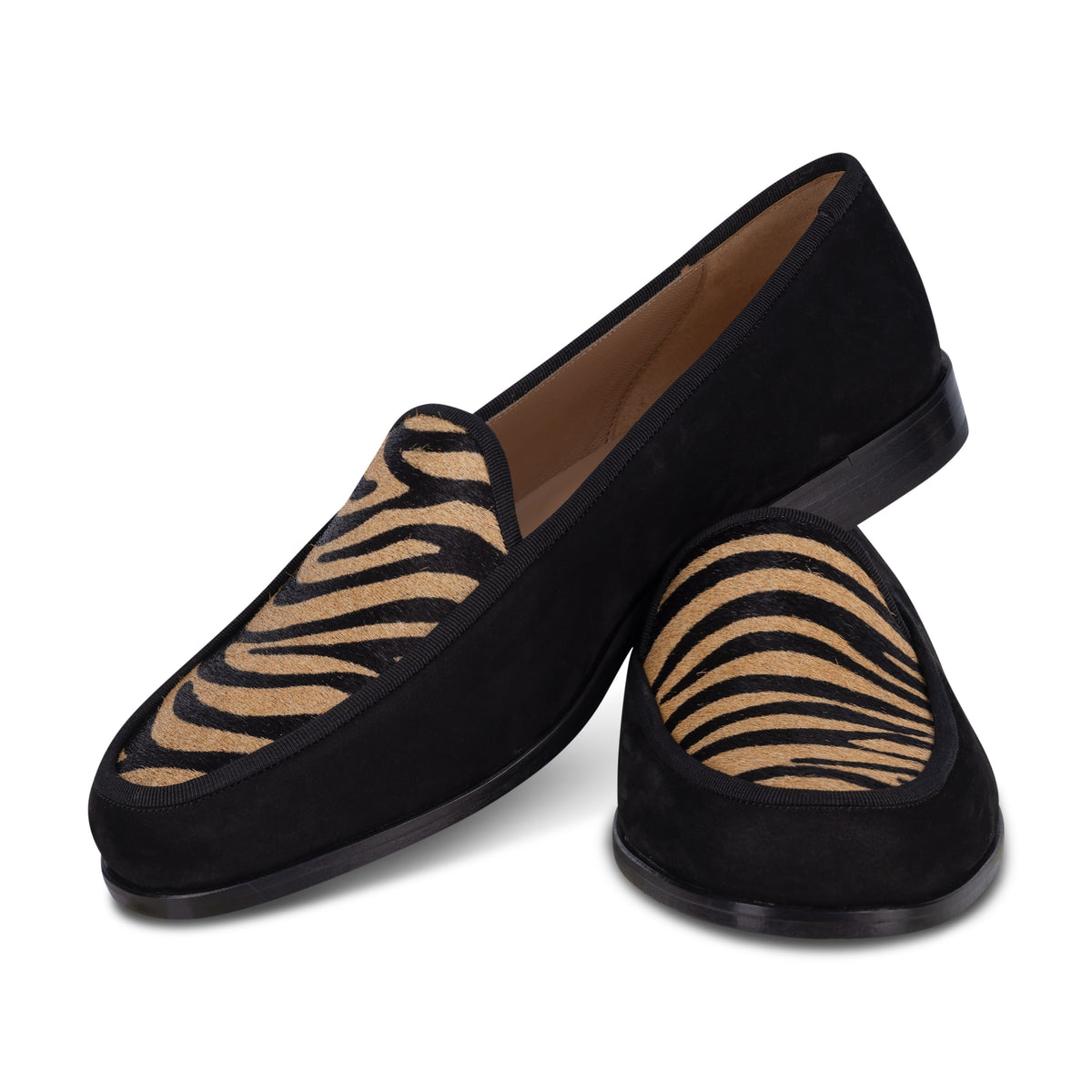 Angled view of Men’s Stripes Camel Leather Lux loafers showcasing camel and black zebra-print hair-on-hide vamps on white