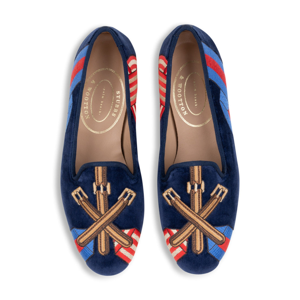 Top view of Paddock Naval Slipper showcasing crossed leather tack embroidery over striped racing silks on white background