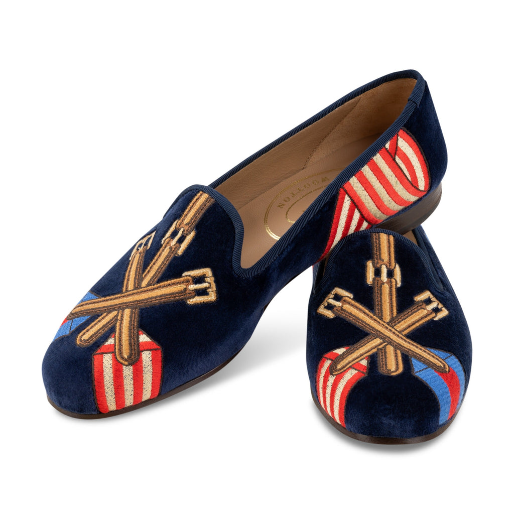 Three quarter view of Paddock Naval Slipper showcasing crossed tack embroidery and striped racing silks on a white background