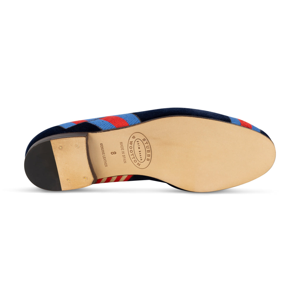 Bottom view of Paddock Naval Slipper showcasing leather sole, stacked heel, and striped trim on white background