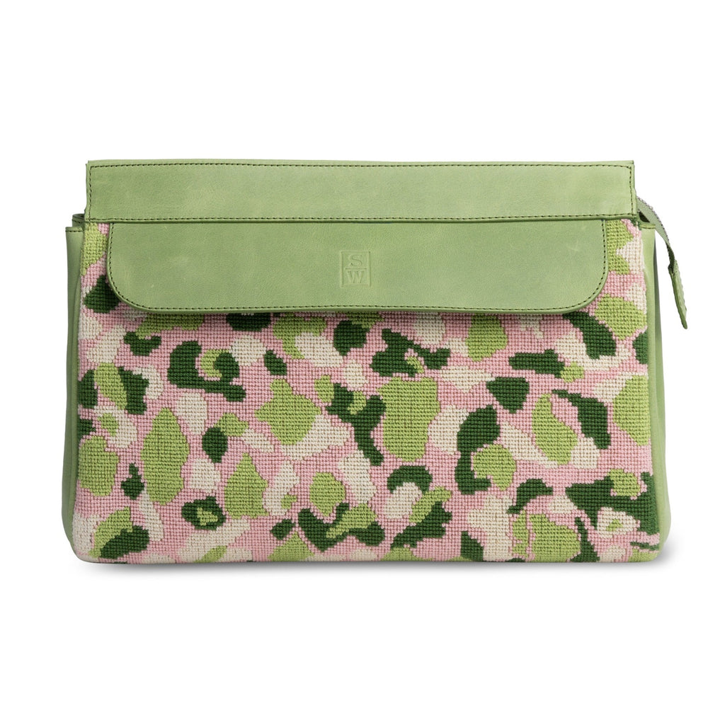 Front view of Hidden Palm Needlepoint Traveler showcasing pink and green camouflage needlepoint with a green leather flap