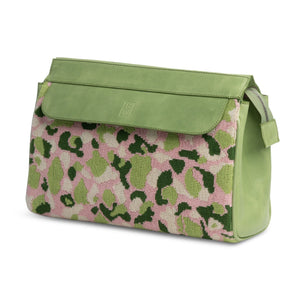 Three-quarter view of Hidden Palm Needlepoint Traveler with pink and green camouflage needlepoint, green flap and strap