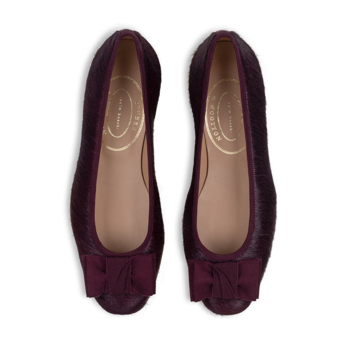 Top view of Pony Burgundy Opera flats showcasing pony hair leather and a tonal grosgrain bow on a white background