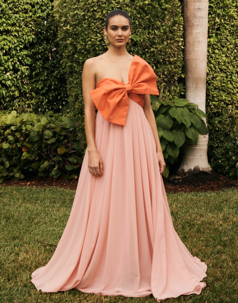 Kiss Me Knot Gown in Bloom Pink chiffon with oversized bow neckline, strapless silhouette, and flowing skirt.