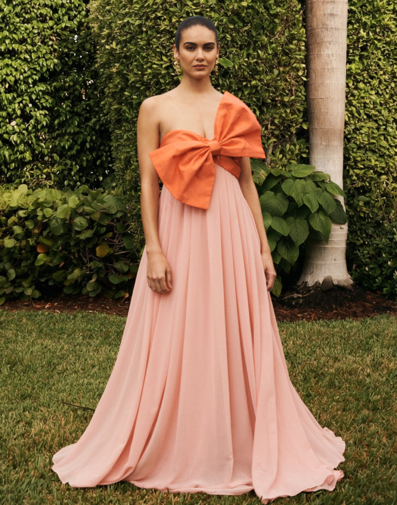 Kiss Me Knot Gown in Bloom Pink chiffon with oversized bow neckline, strapless silhouette, and flowing skirt.