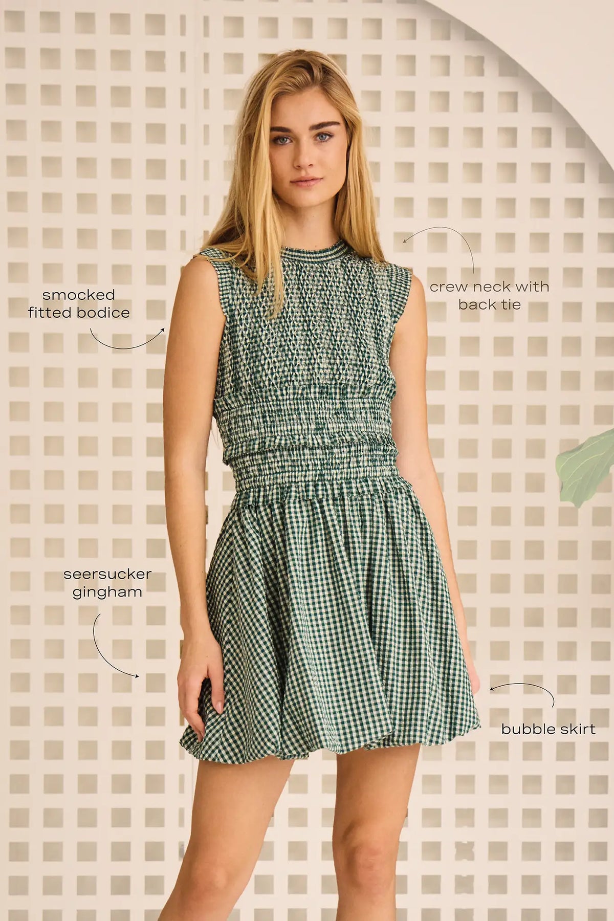 The Anita Dress has a diamond-smocked bodice, flutter cap sleeves, a back tie and a bubble skirt.