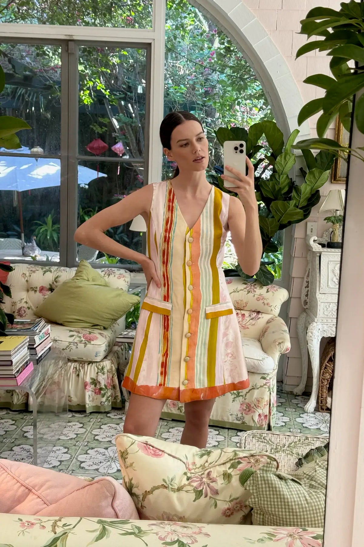 The Suni Dress is a fitted vest-style mini with a V-neck, faux waist pockets, and A-line skirt.