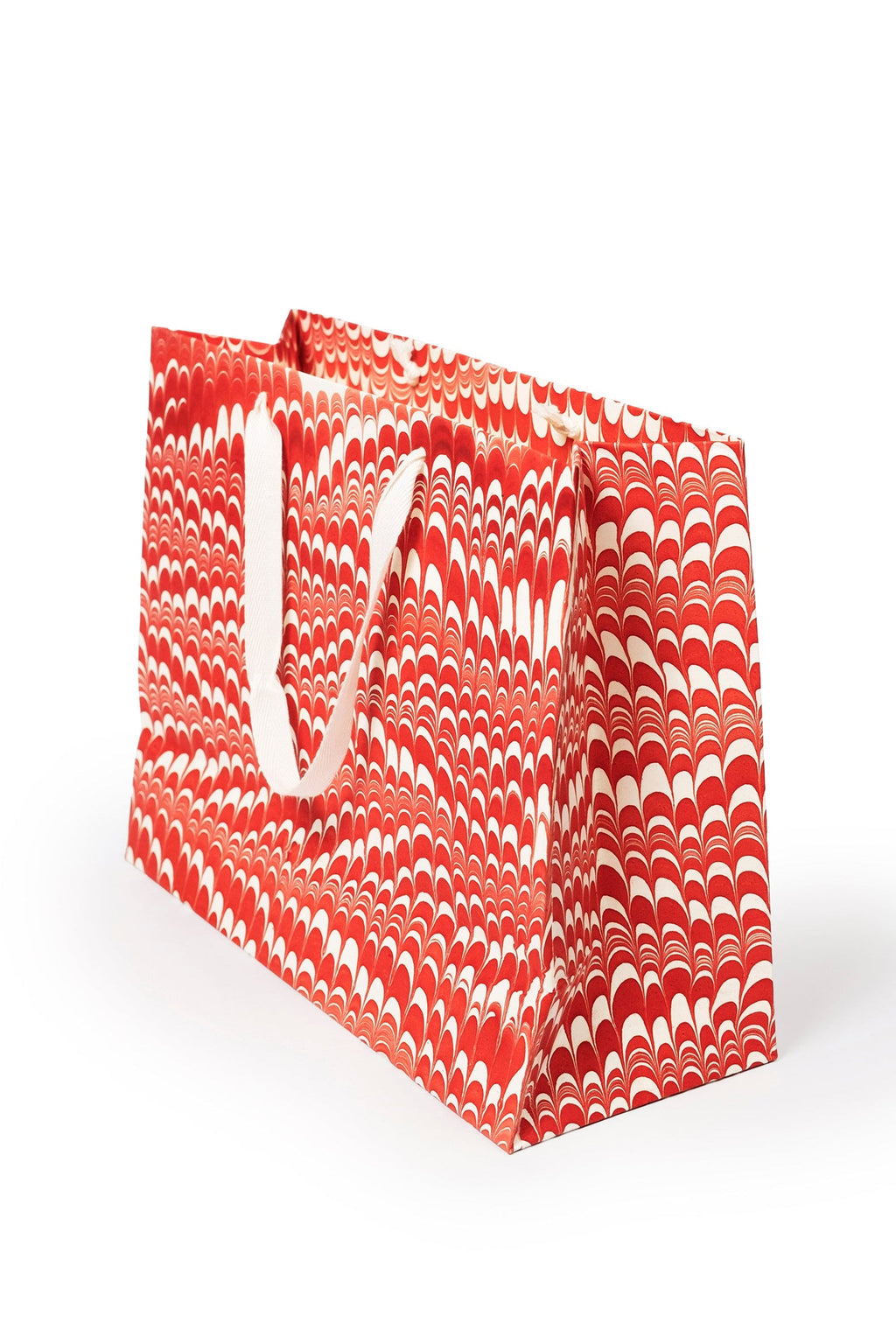 Red and white candy cane swirl hand marbled gift bag with white handles by Inner Child