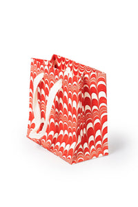 Red and white candy cane swirl hand marbled gift bag with white handles by Inner Child