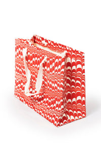 Red and white candy cane swirl hand marbled gift bag with white handles by Inner Child